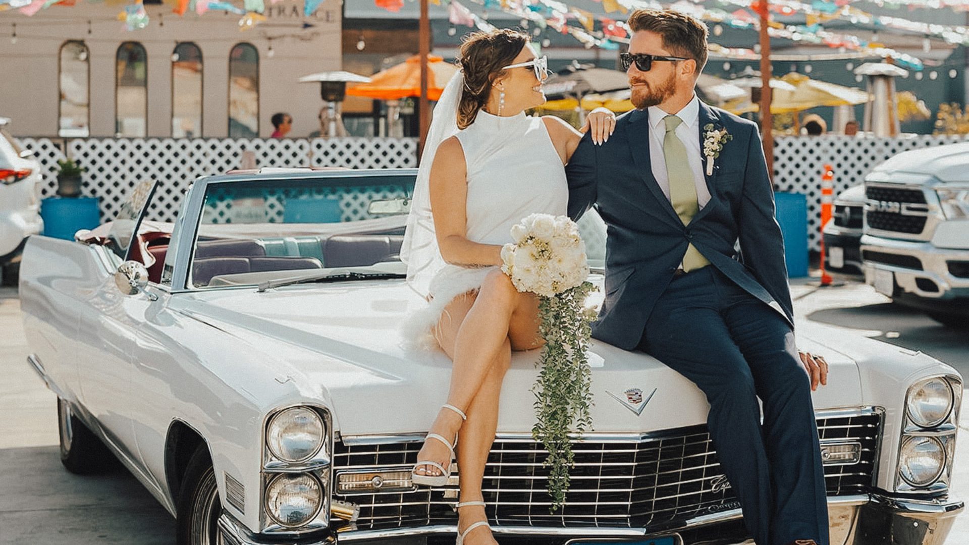 Newlyweds with a classic Cadillac convertible from Peacock Rentals